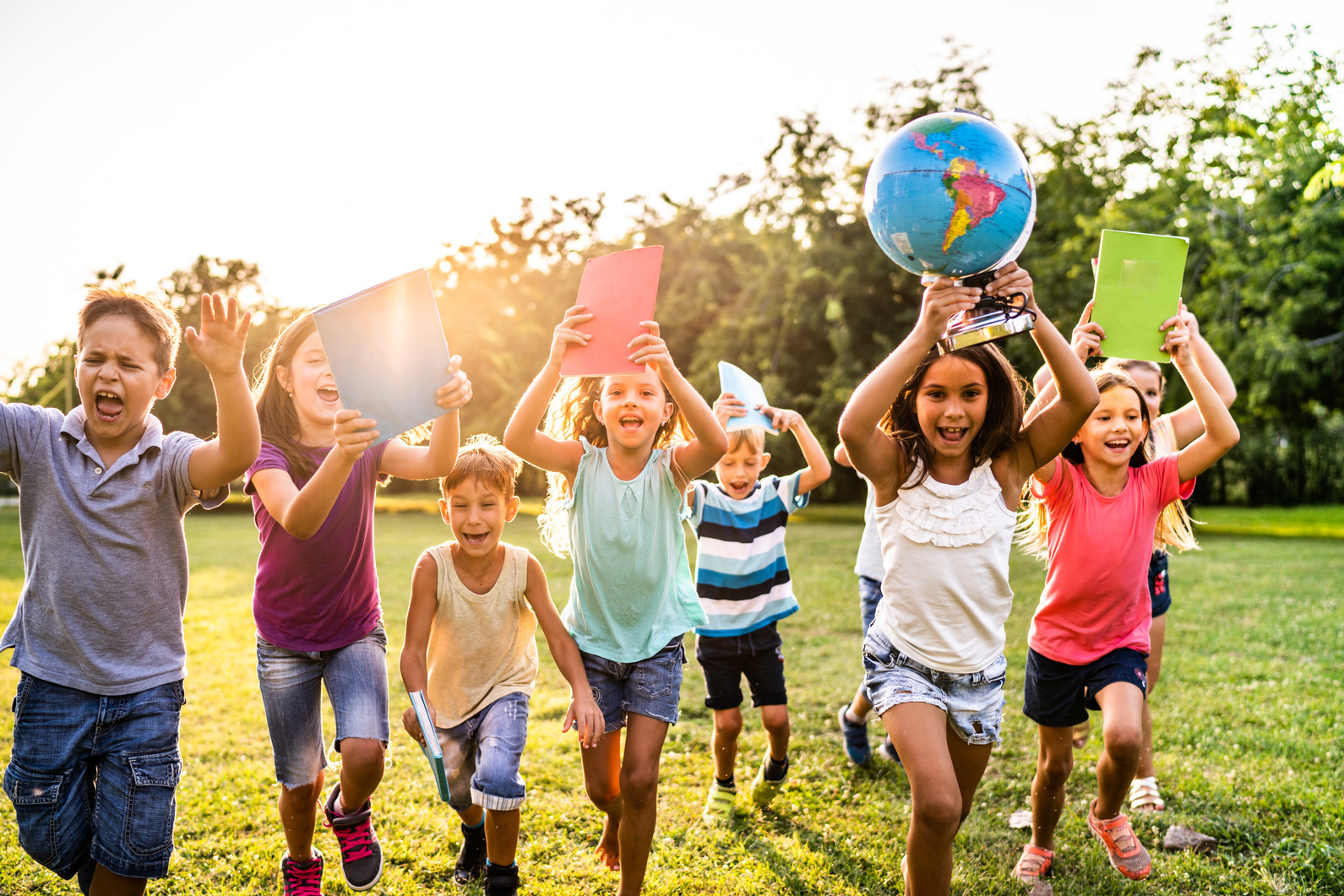 Happy school children running